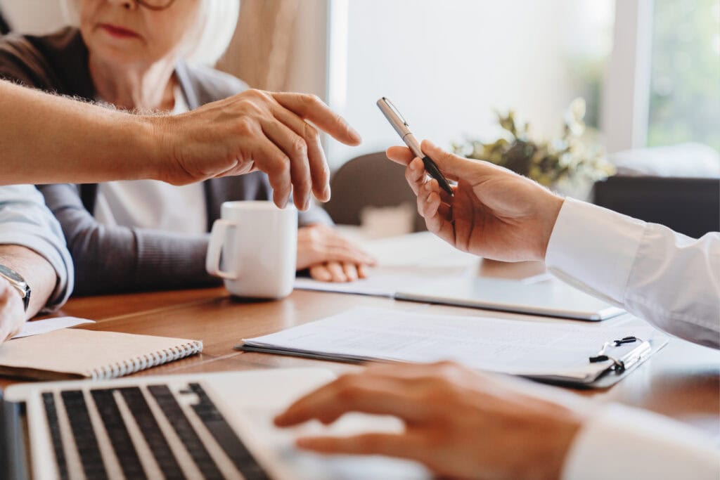 Real estate professionals reviewing documents for appraisal waiver eligibility
