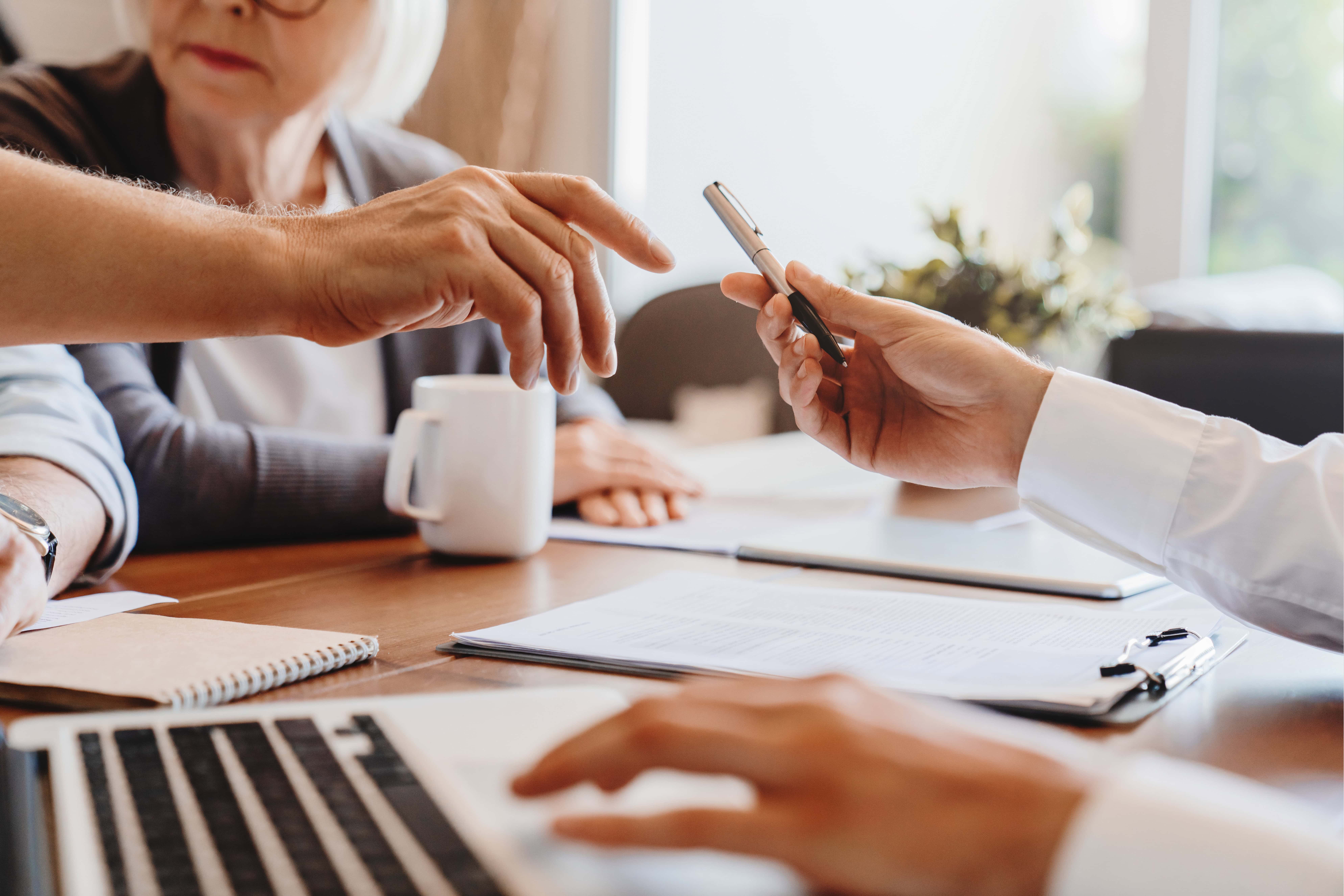 Real estate professionals reviewing documents for appraisal waiver eligibility