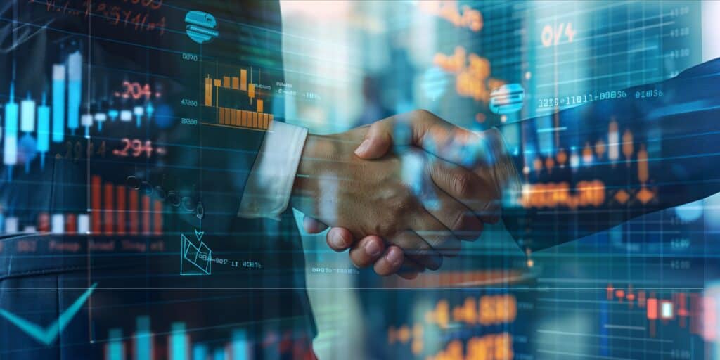 Business handshake over digital financial graphs and charts